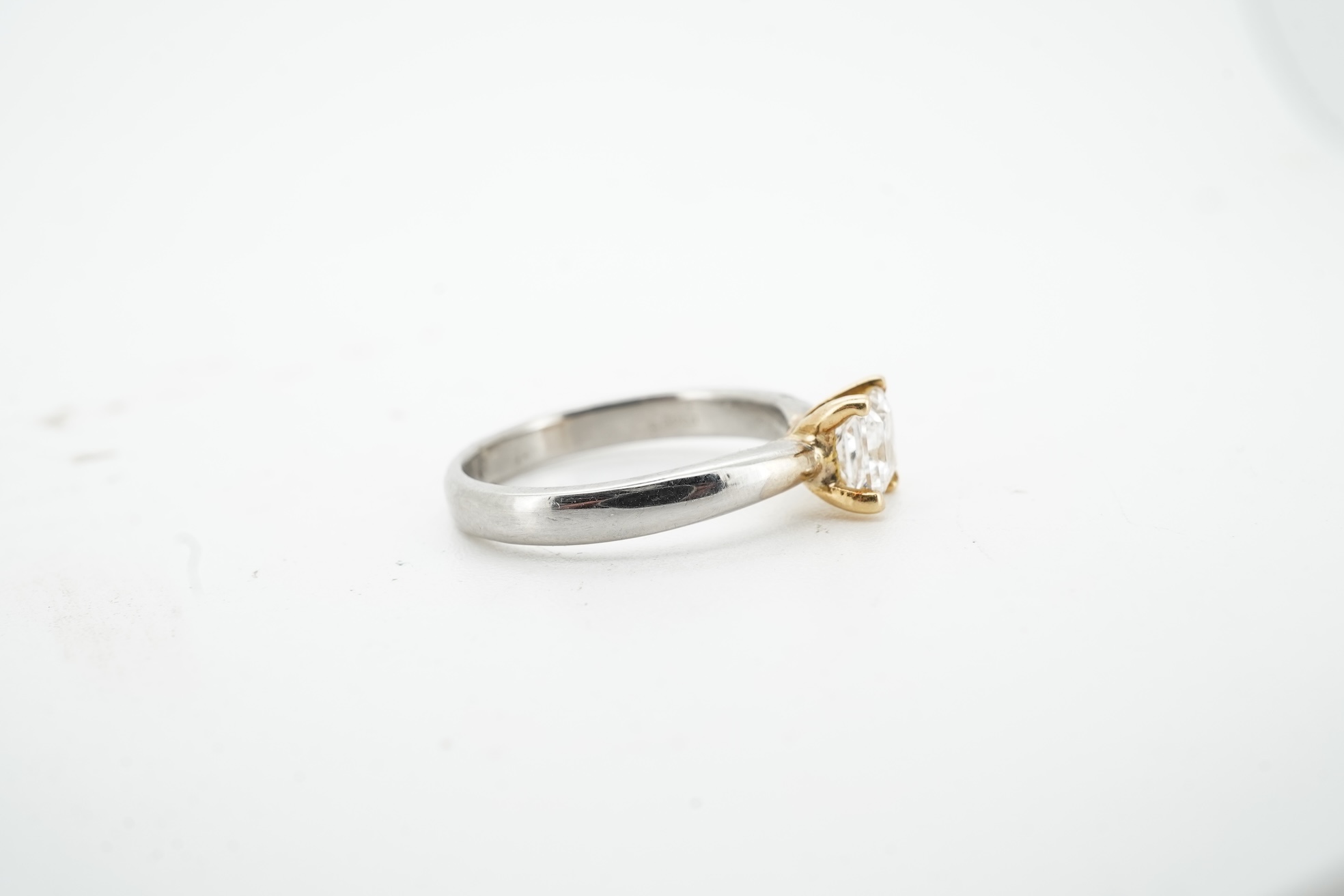 A diamond ring, claw-set with a princess-cut diamond weighing approximately 0.58 carats, mounted in platinum, size F1/2, British hallmarks, gross weight approximately 2 grams